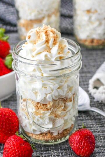 Cheesecake mousse topped with graham cracker crumbs served in a mason jar.