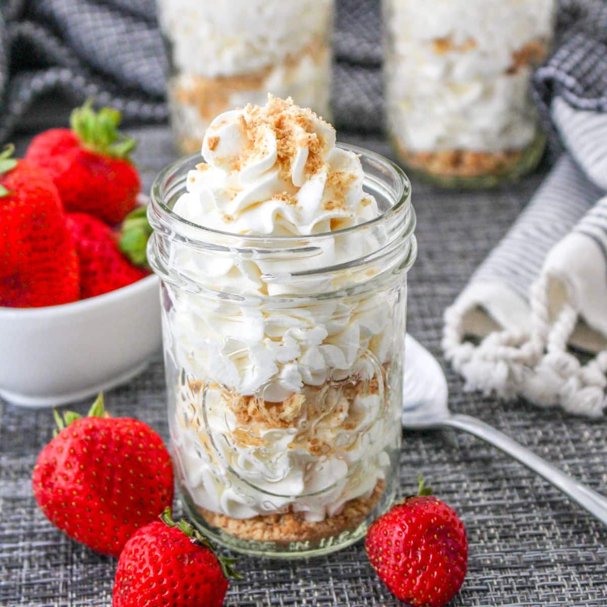 Cheesecake mousse topped with graham cracker crumbs served in a mason jar.