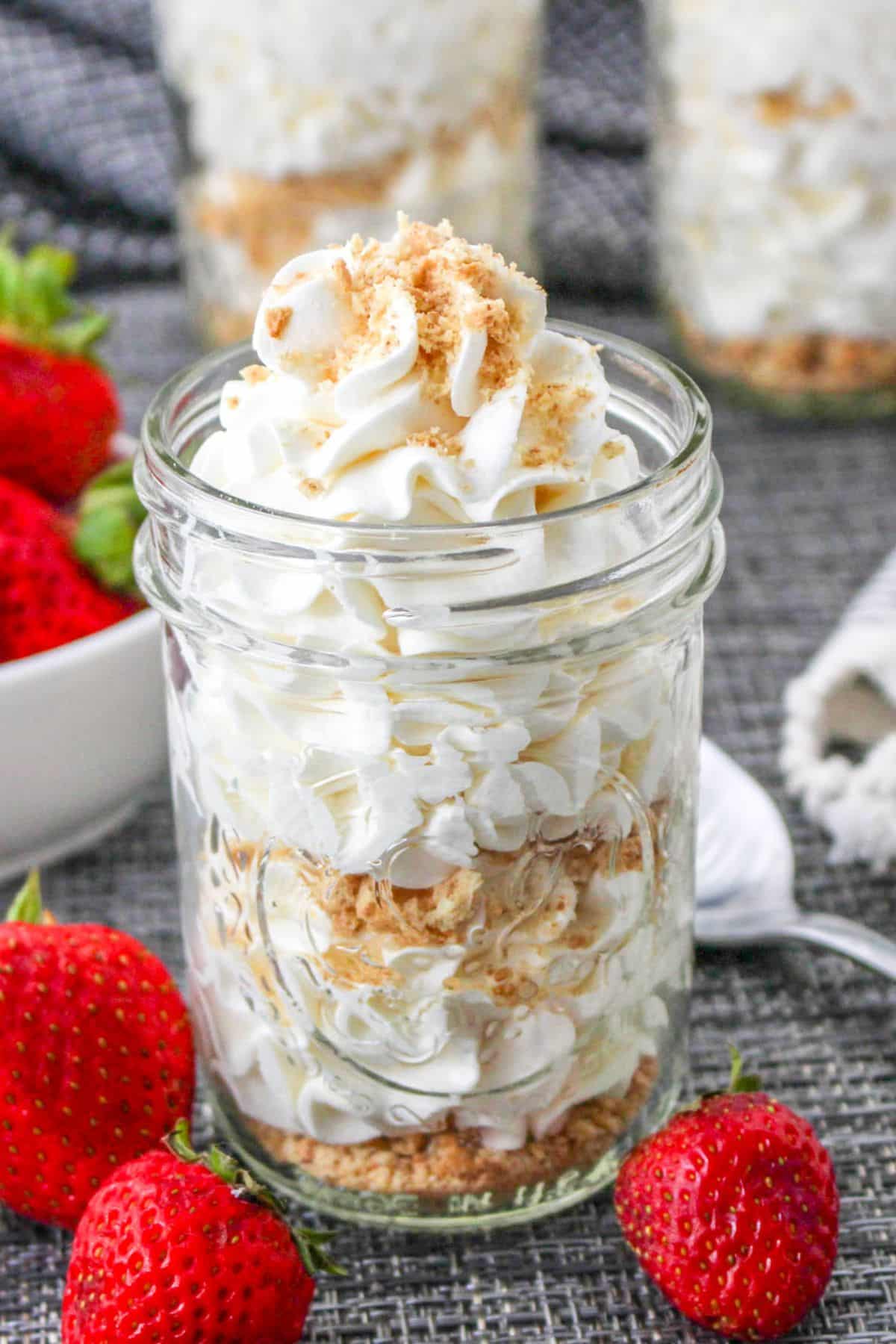 Cheesecake mousse topped with graham cracker crumbs served in a mason jar. 