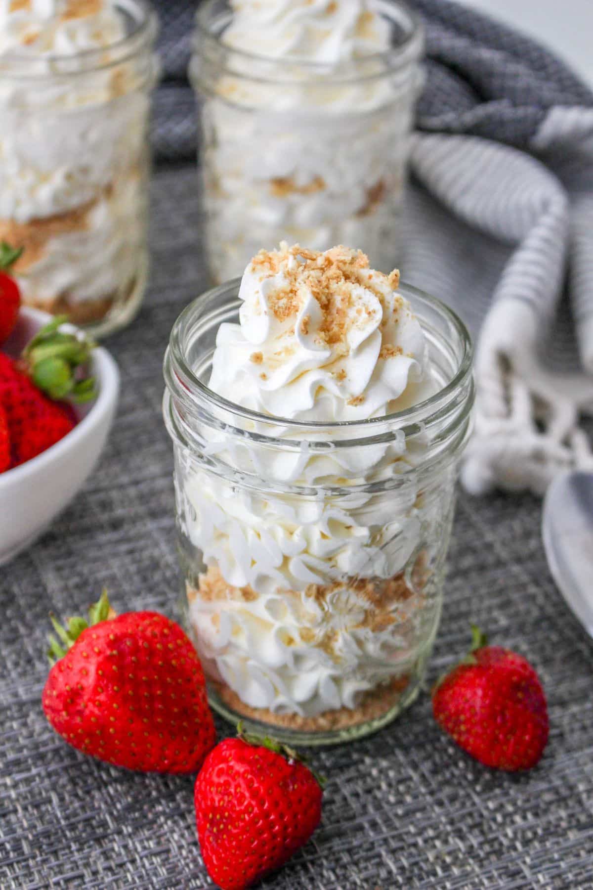 Cheesecake mousse topped with graham cracker crumbs served in a mason jar.