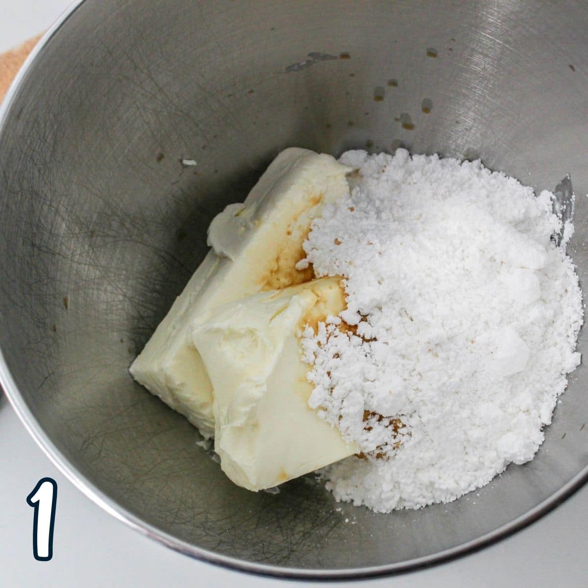 Cream cheese, powdered sugar, and vanilla in a mixing bowl. 
