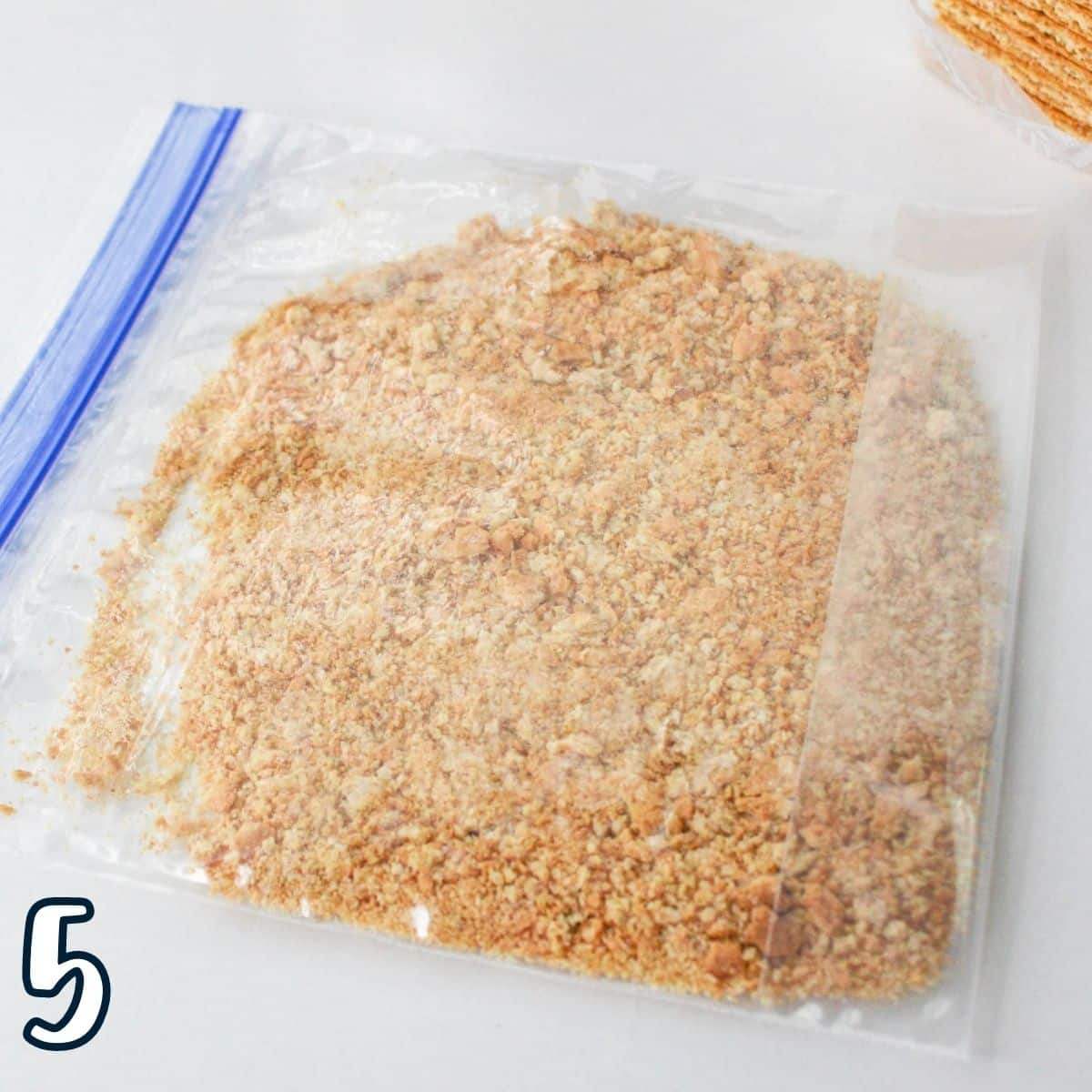 Crushed graham crackers in a plastic bag. 