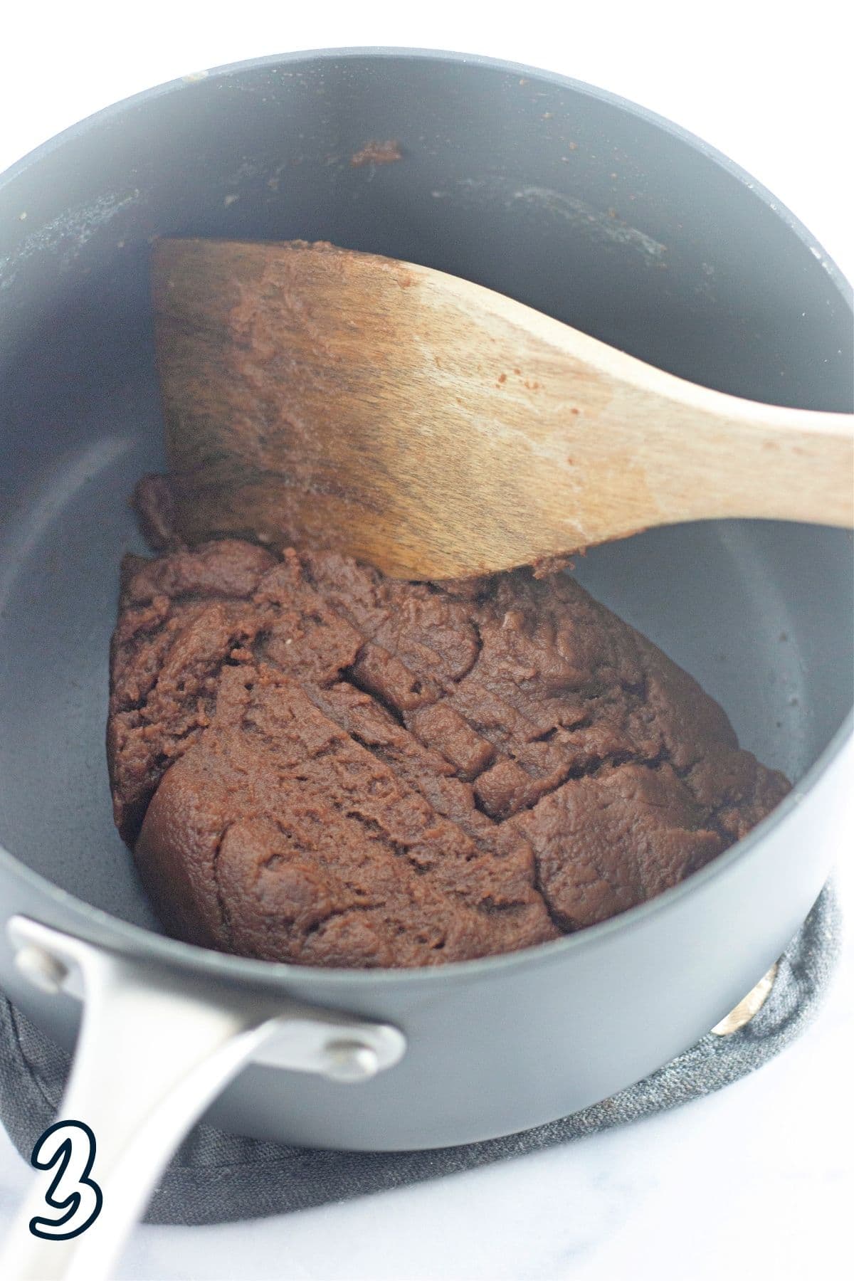 Cream puff dough in a sauce pan. 