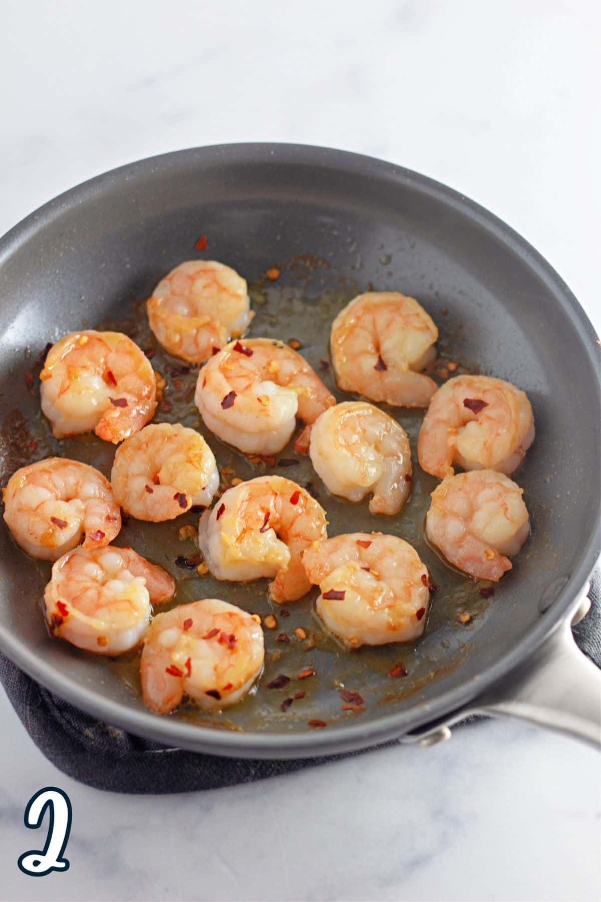 Shrimp cooking in a skillet.