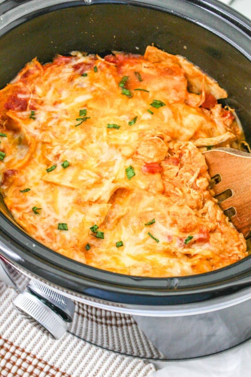 Finished chicken enchiladas in a slow cooker ready to serve.