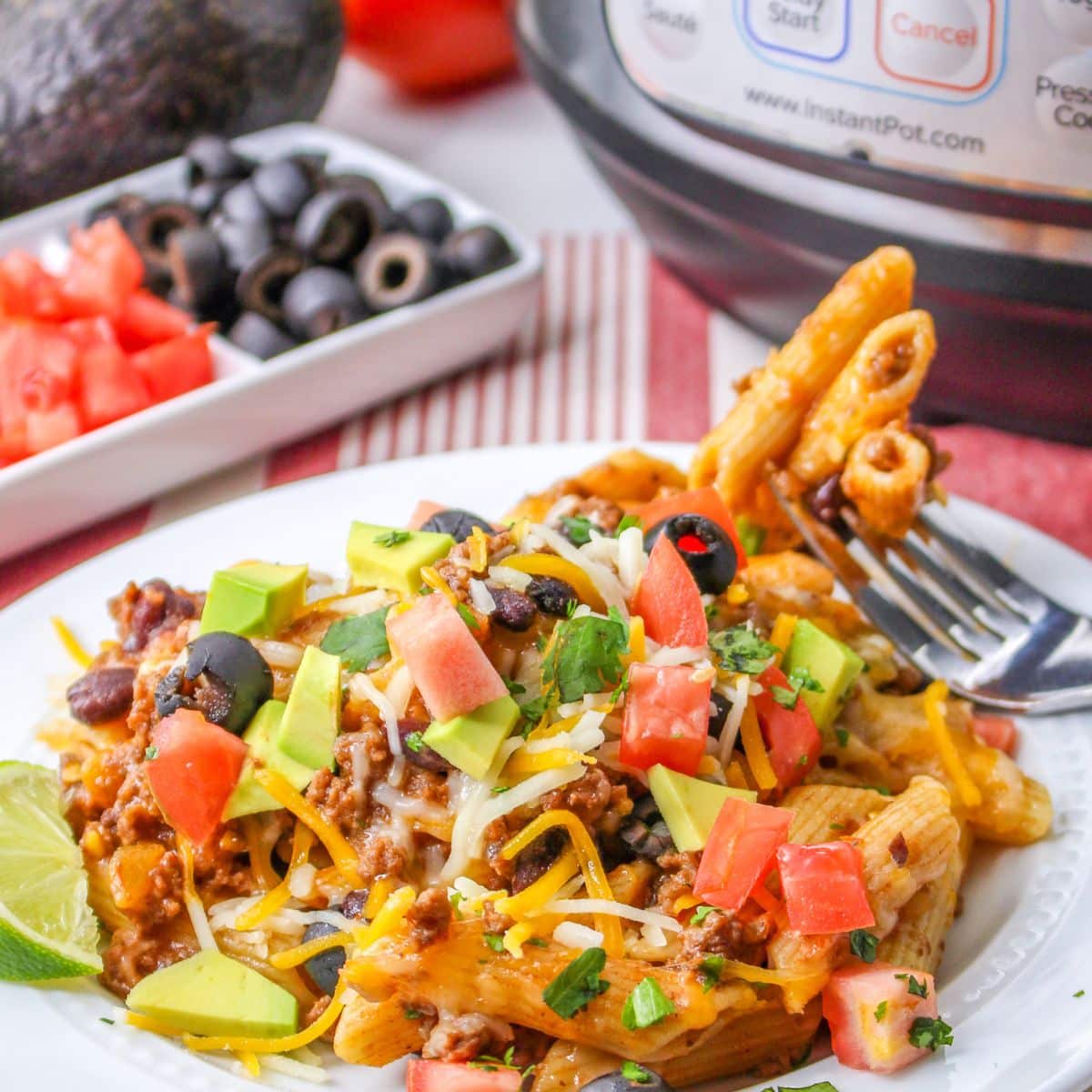 A plate of taco flavored pasta on a white plate.