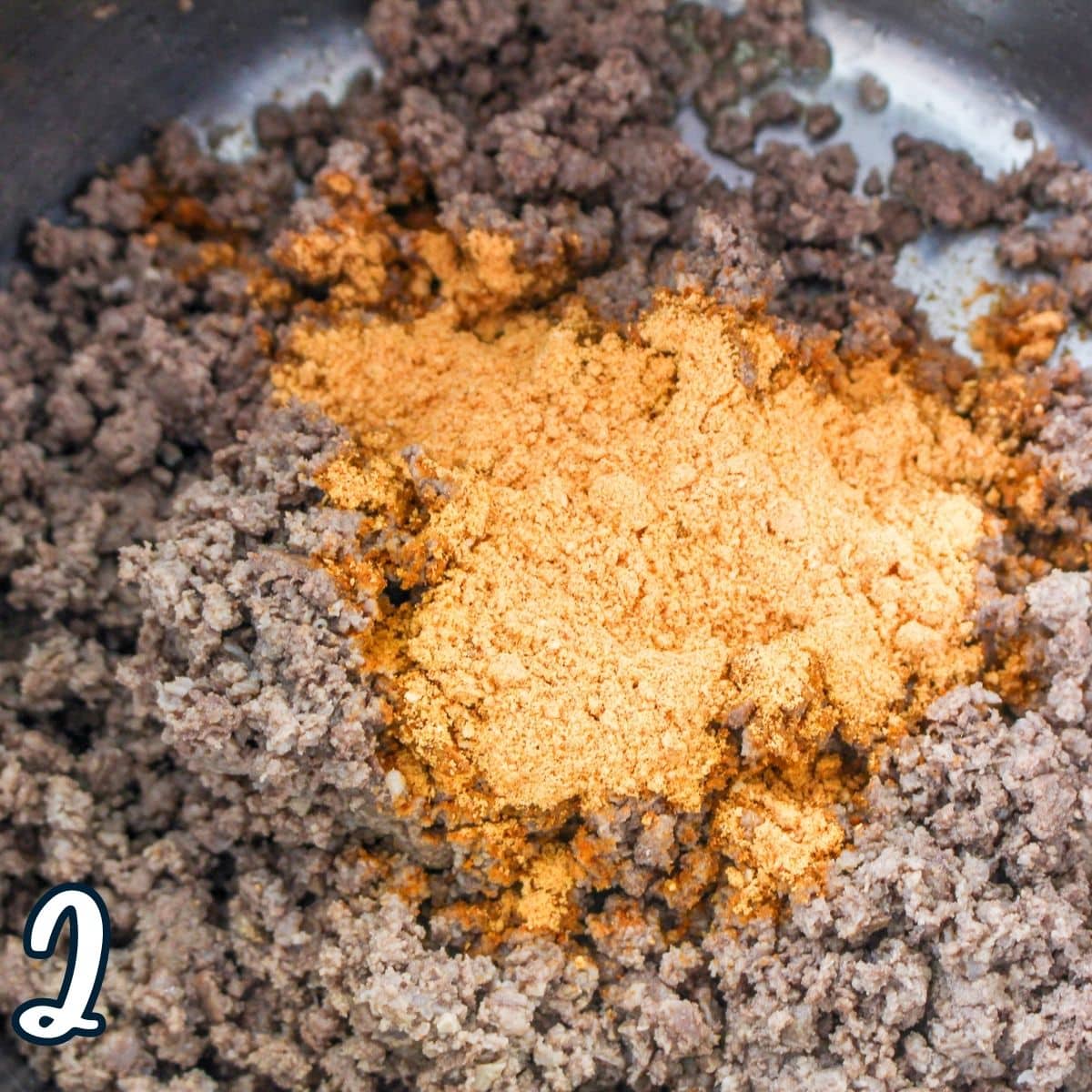 Ground meat and taco seasoning in a pot. 