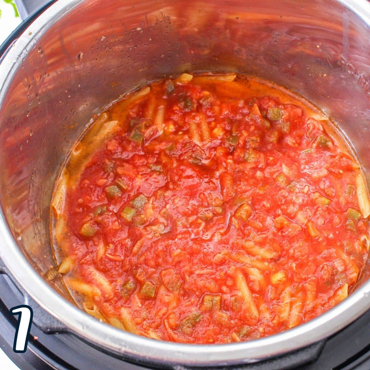 Salsa added to a pot with other ingredients for taco pasta.
