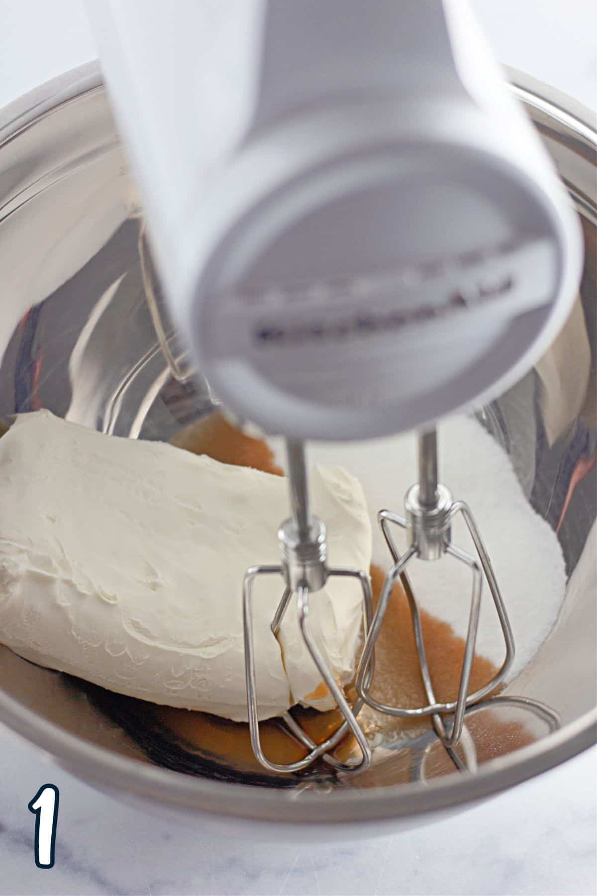 Cream cheese, sugar and vanilla in a mixing bowl with a stand mixer. 