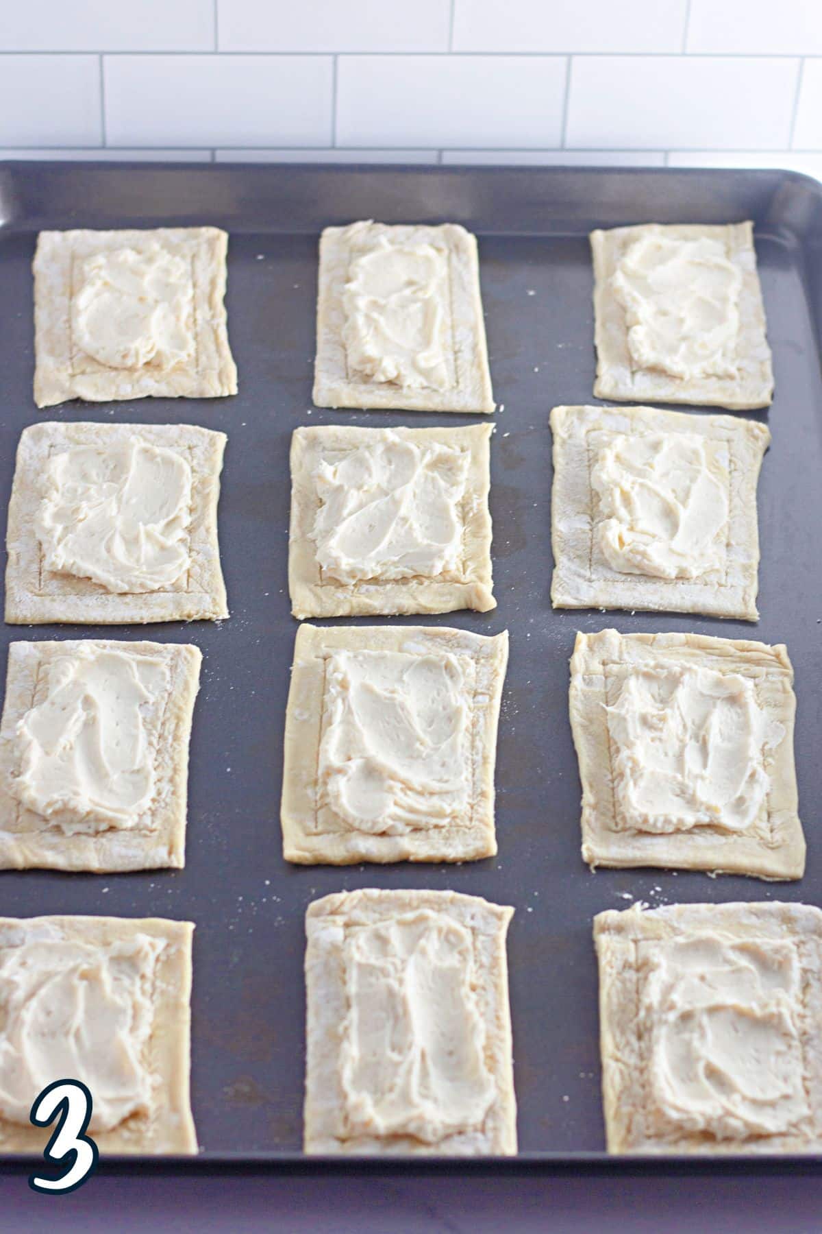 Cream cheese Danish filling spread onto puff pastry rectangles. 