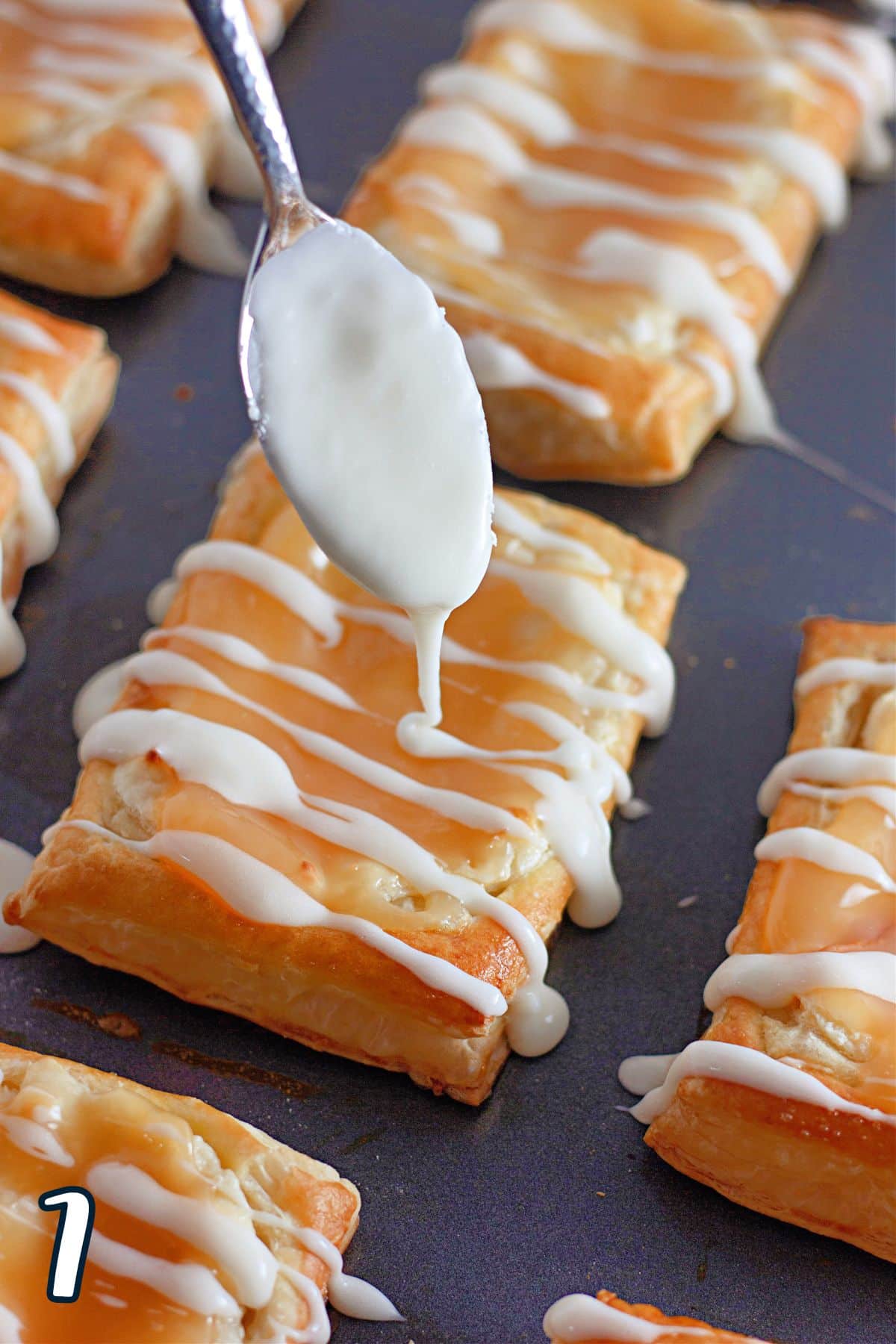 Glaze being drizzled over lemon pastries. 