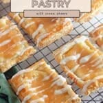 Lemon Cream Cheese Pastry delights with icing drizzle are cooling on a wire rack, ready to enjoy.