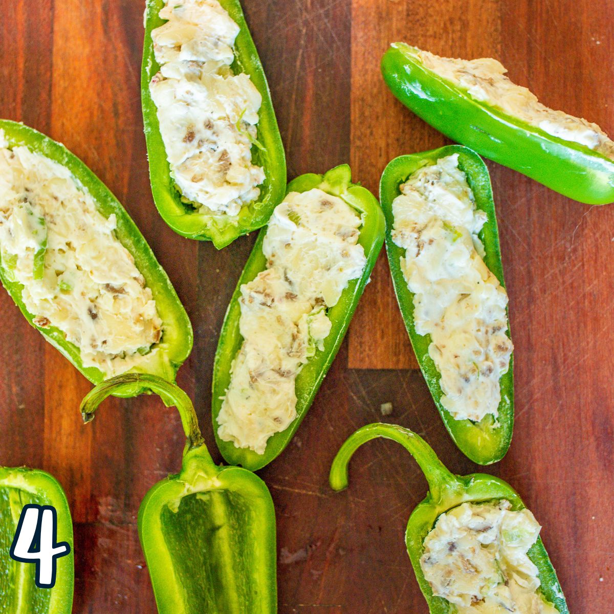 Cream cheese filling in jalapenos that have been split in half. 