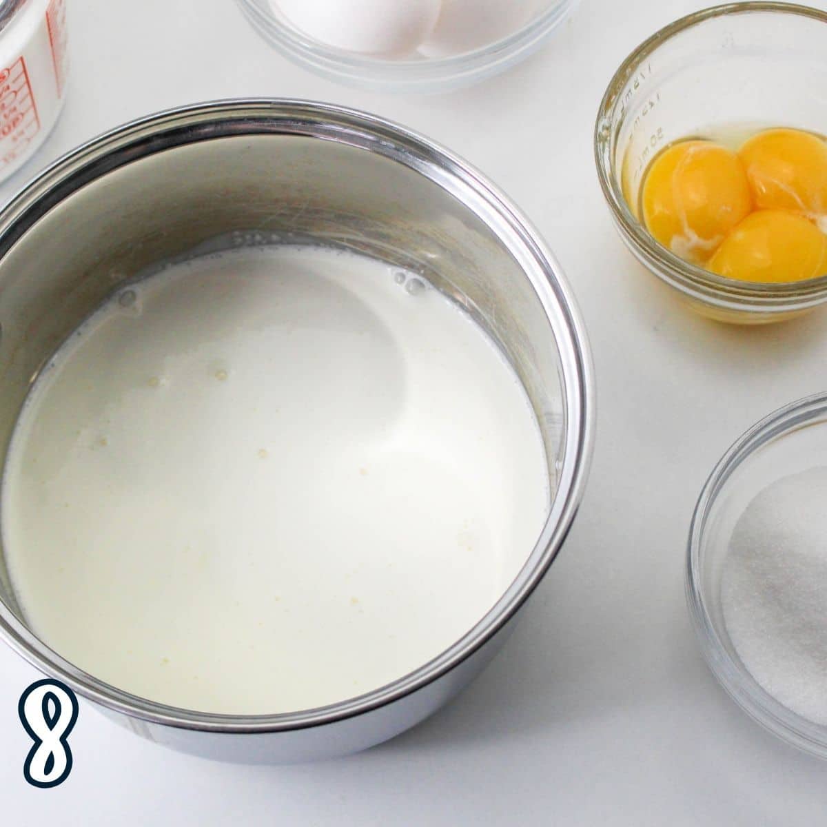 Heavy cream with sugar in a saucepan. 