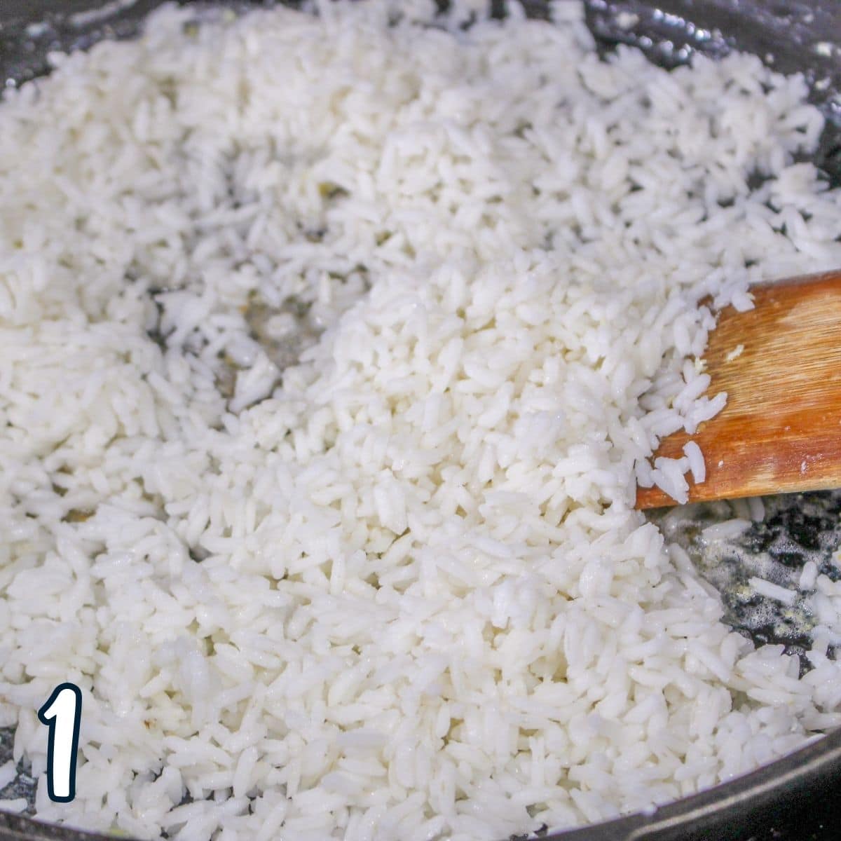 Cooked rice in a hot skillet to make fried rice. 