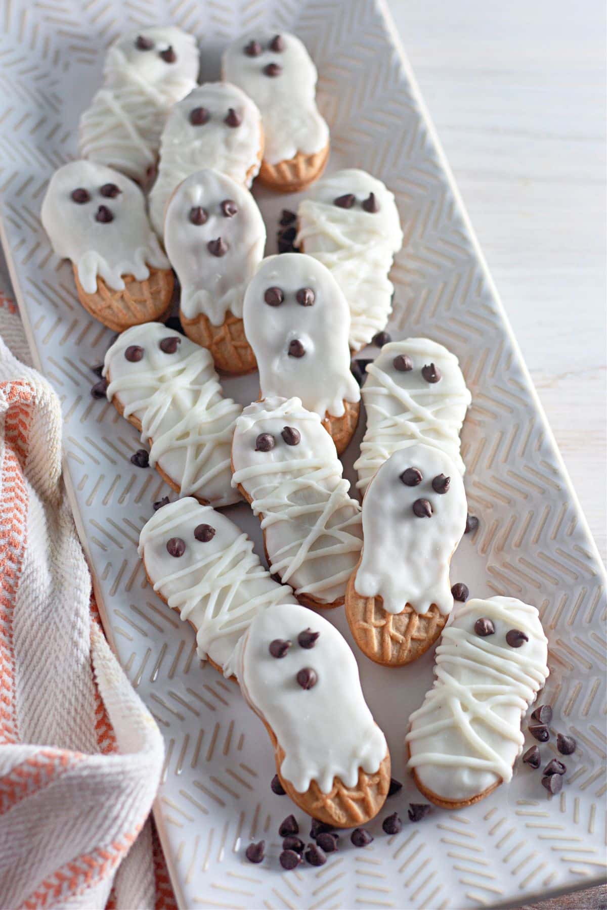 Ghost and Mummy decorated cookies on a white platter.
