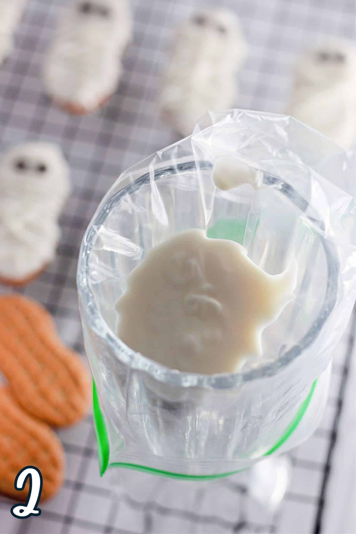 White melting chocolate in a plastic bag that is nestled in a glass. 
