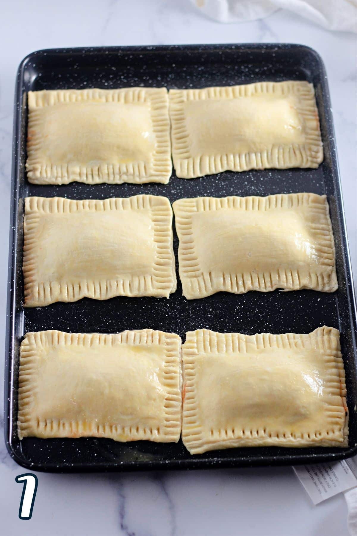 The edges crimped on six puff pastry pockets. 