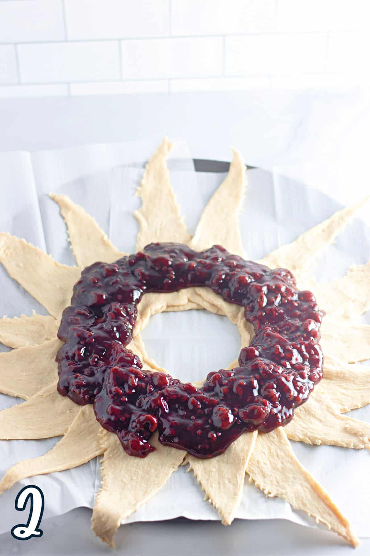 A raspberry wreath on a sheet of paper.