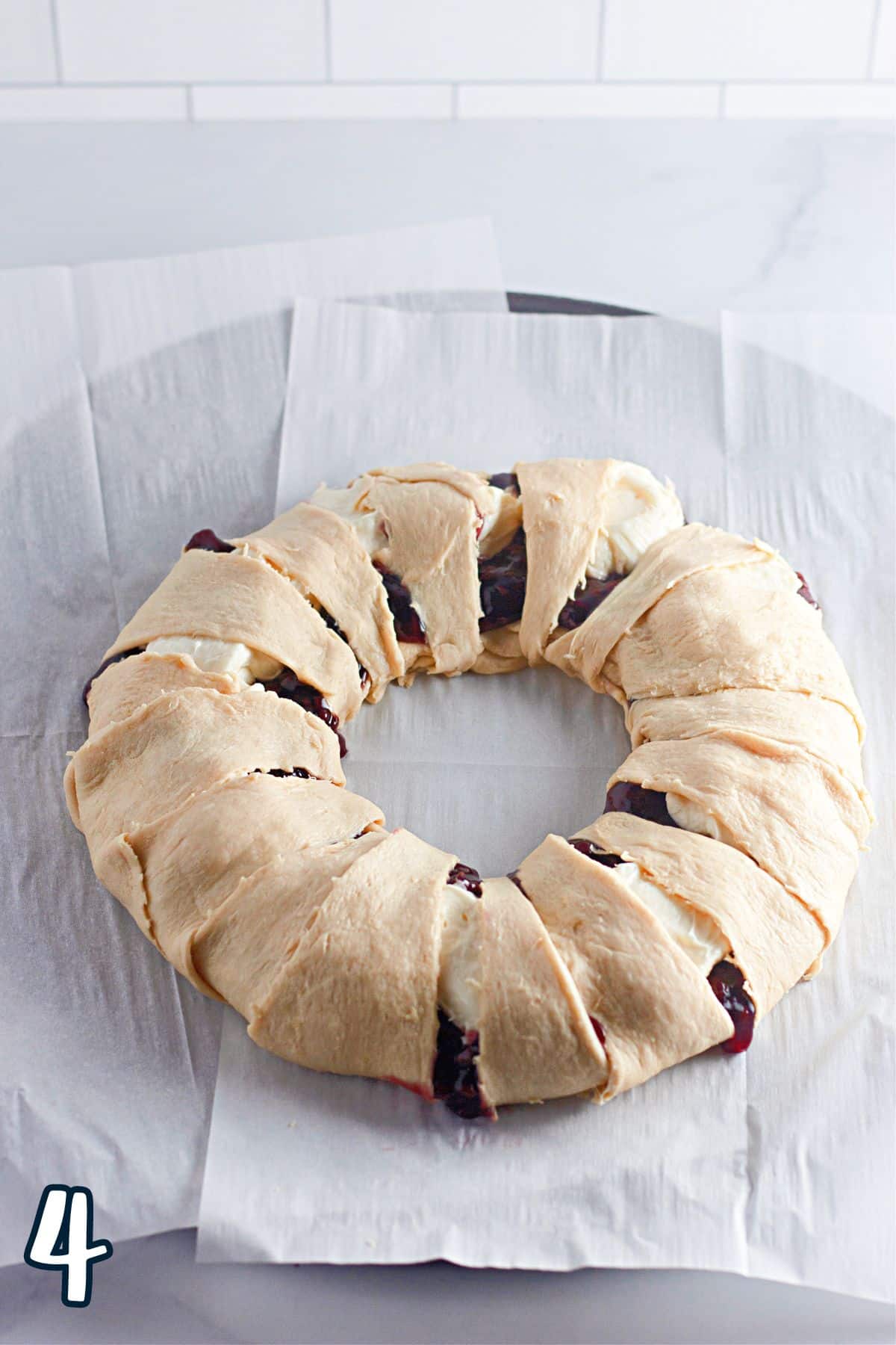 A berry wreath on a baking sheet.