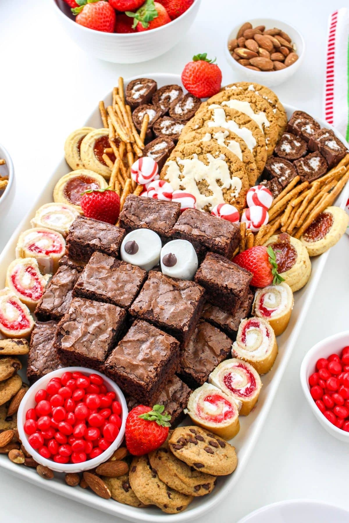 A dessert platter with brownies, cookies, and candies.