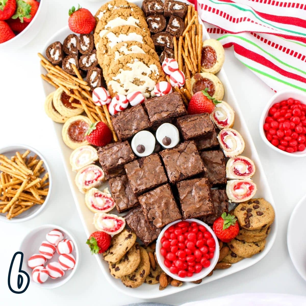 A christmas dessert platter with cookies and brownies.