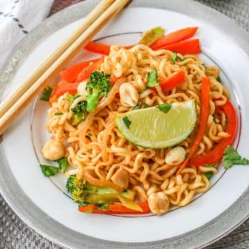 A plate with noodles and vegetables on it.