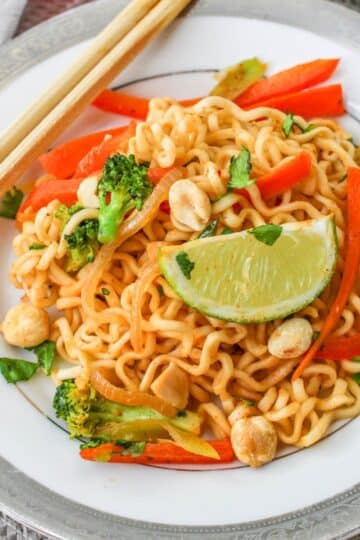 A plate with noodles and vegetables on it.