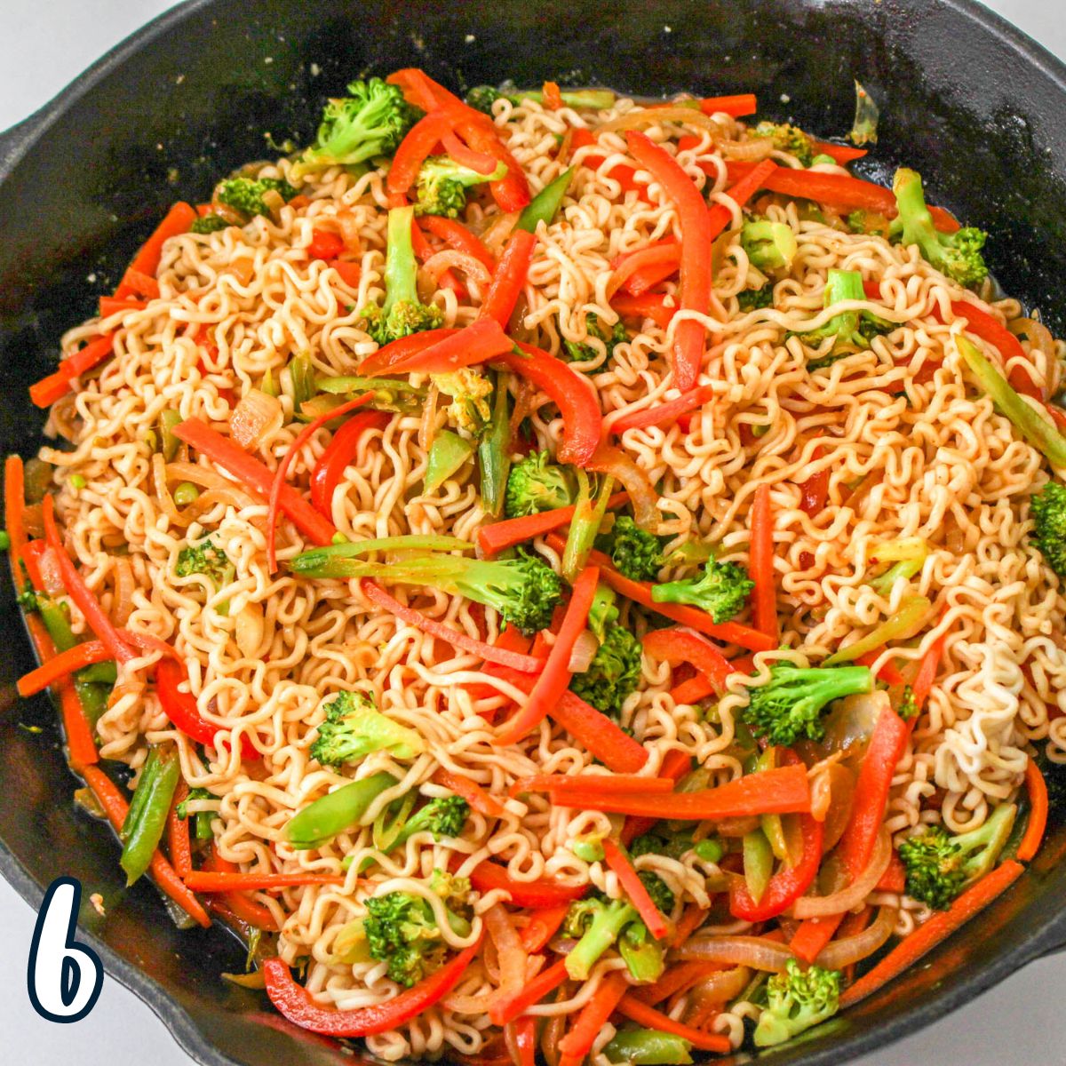 A pan with noodles and vegetables in it.