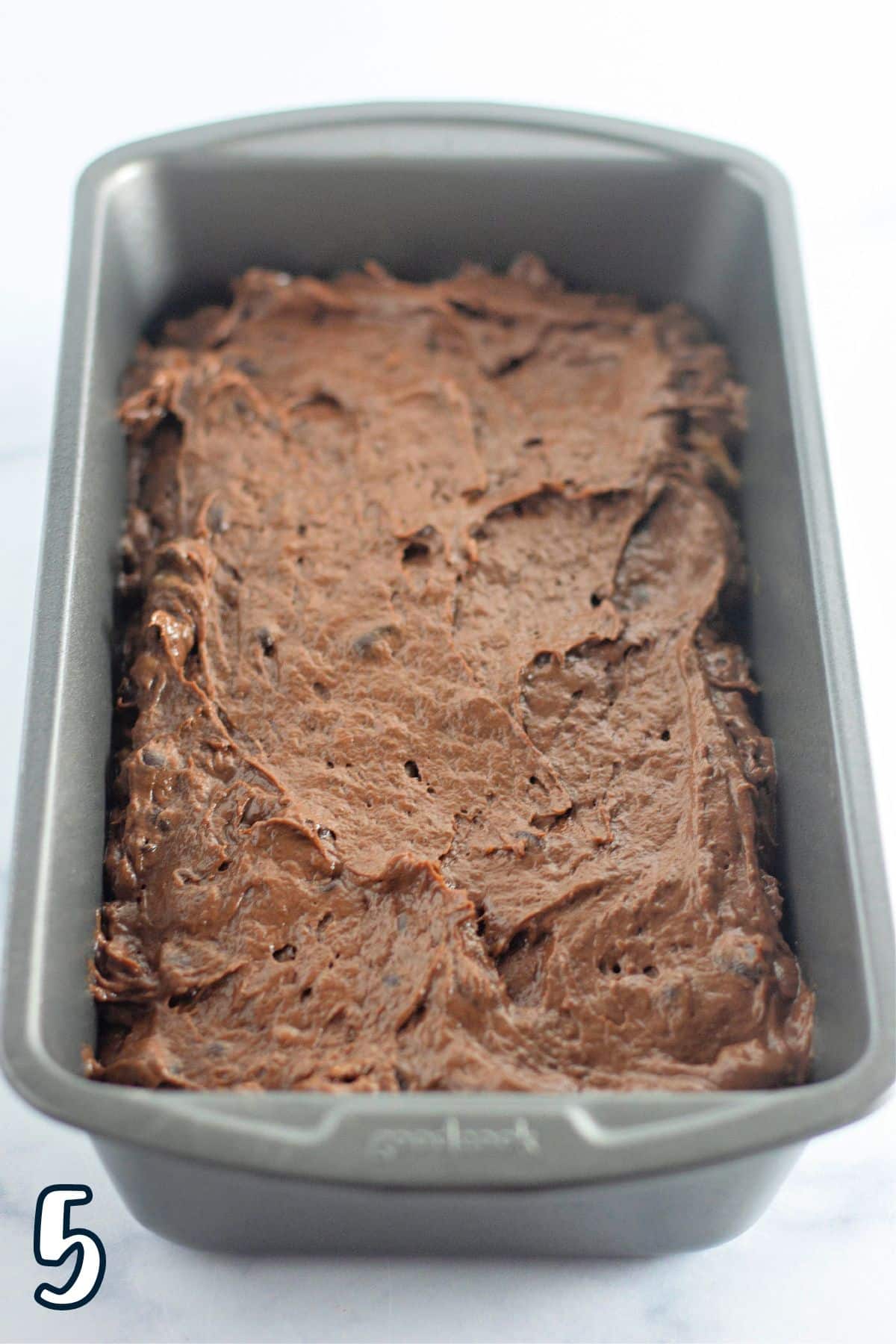 Chocolate banana bread batter in a loaf pan.