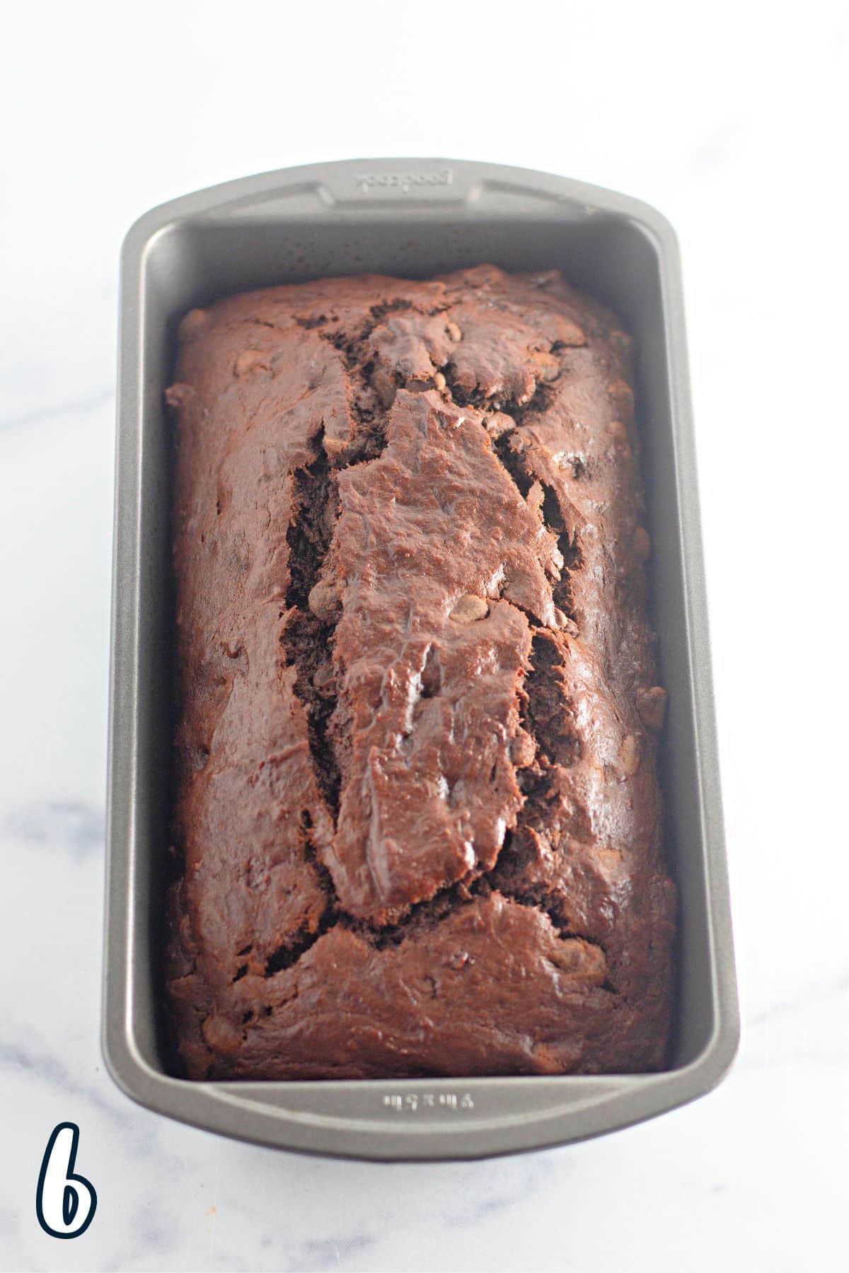 A just baked loaf of chocolate banana bread in a pan.