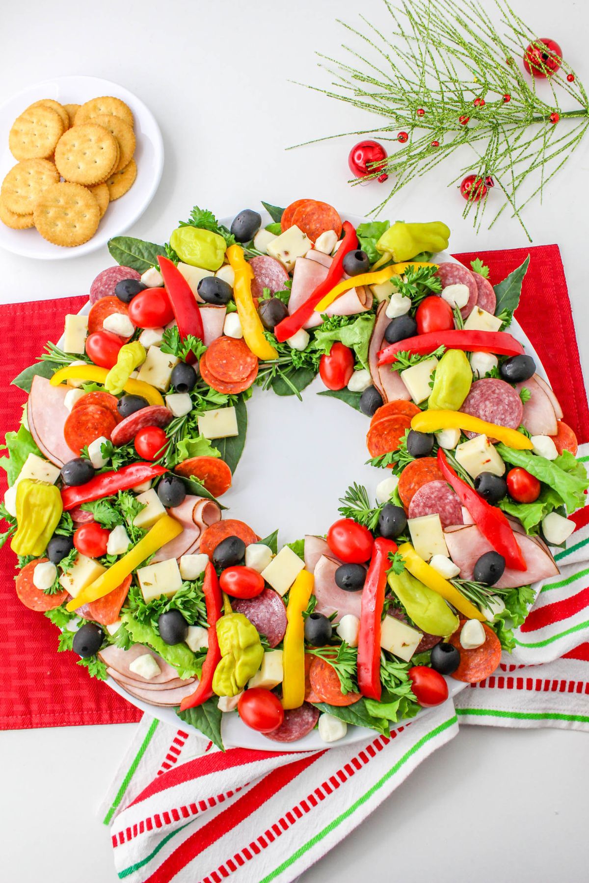 A wreath of vegetables and meats on a plate.