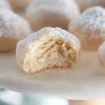 A plate of cookies with powdered sugar on it.