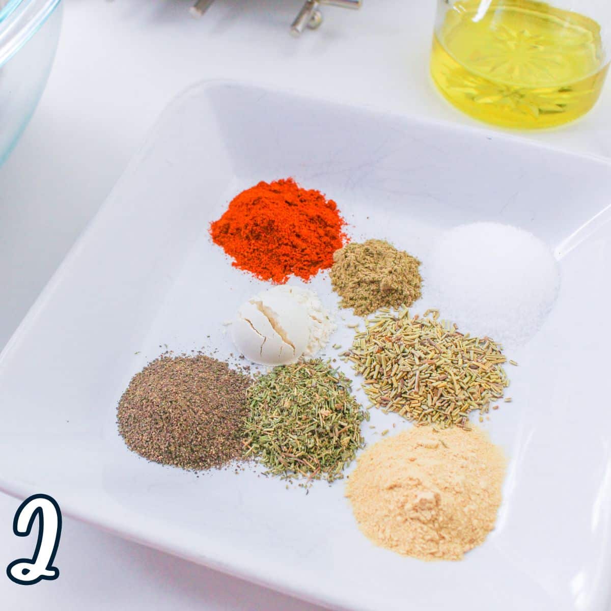 A white plate with spices and ingredients on it.