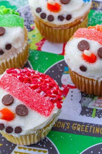 Snowman cupcakes decorated with frosting and sprinkles. These adorable snowman cupcakes will bring joy to any winter celebration. The fluffy frosting creates a snowy texture, while the colorful sprinkles add a festive touch.