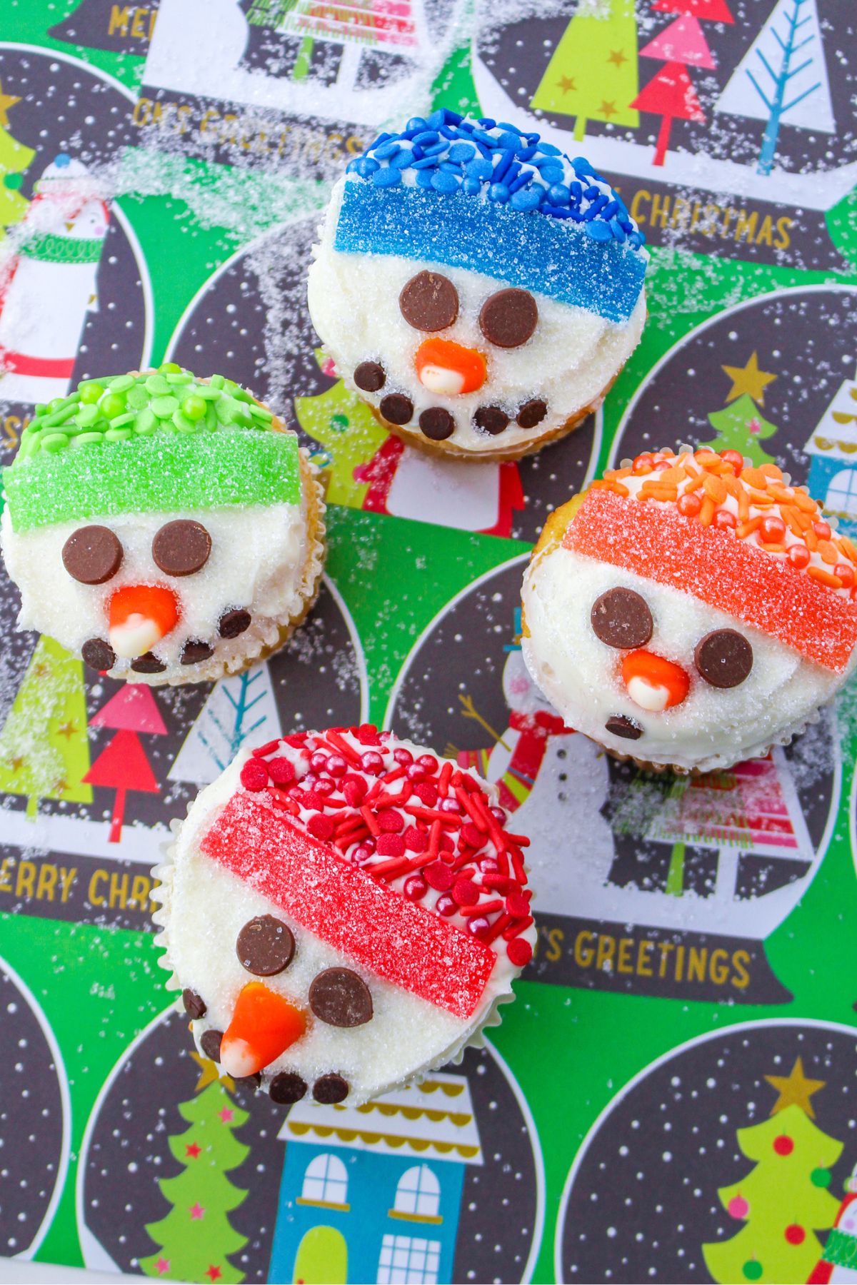 Snowman cupcakes on a green background.