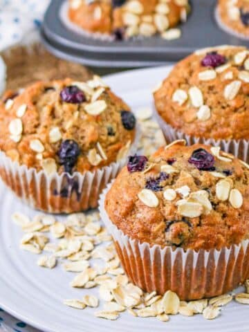 Blueberry muffins with oats and blueberries on a plate.