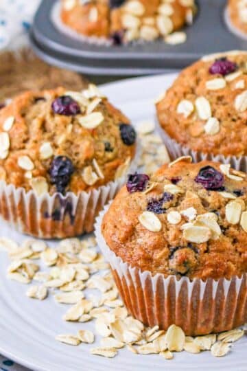 Blueberry muffins with oats and blueberries on a plate.