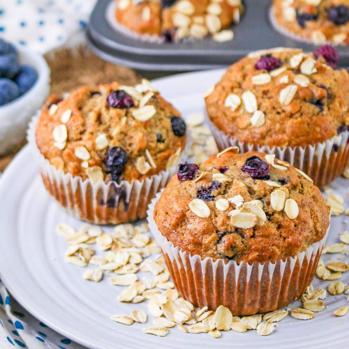 Blueberry muffins with oats and blueberries on a plate.