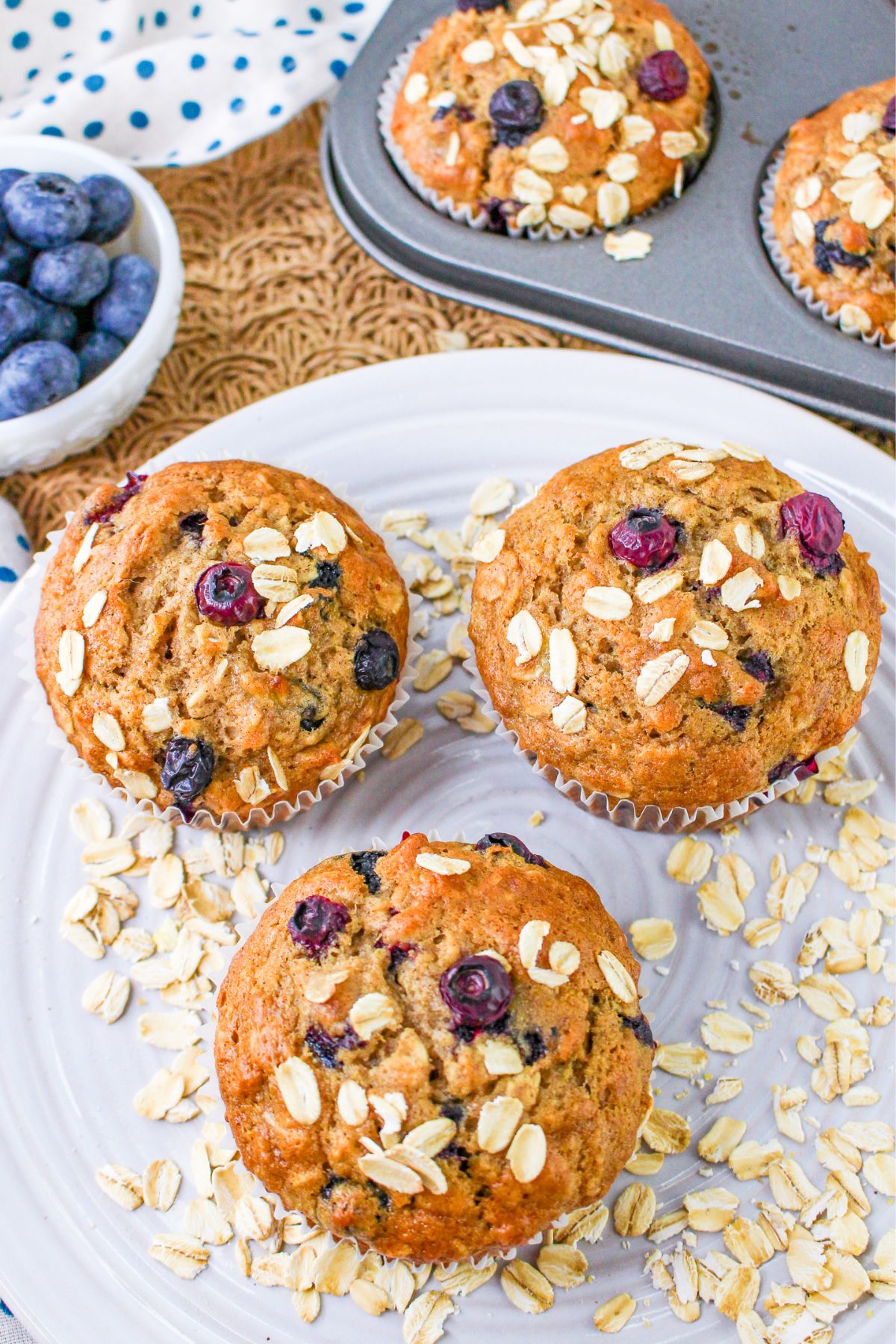 Blueberry muffins with oats and blueberries on a plate.