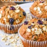 Close-up of Banana Blueberry Oatmeal Muffins on a plate with scattered oats. Delicious Banana Blueberry Oatmeal Muffins.