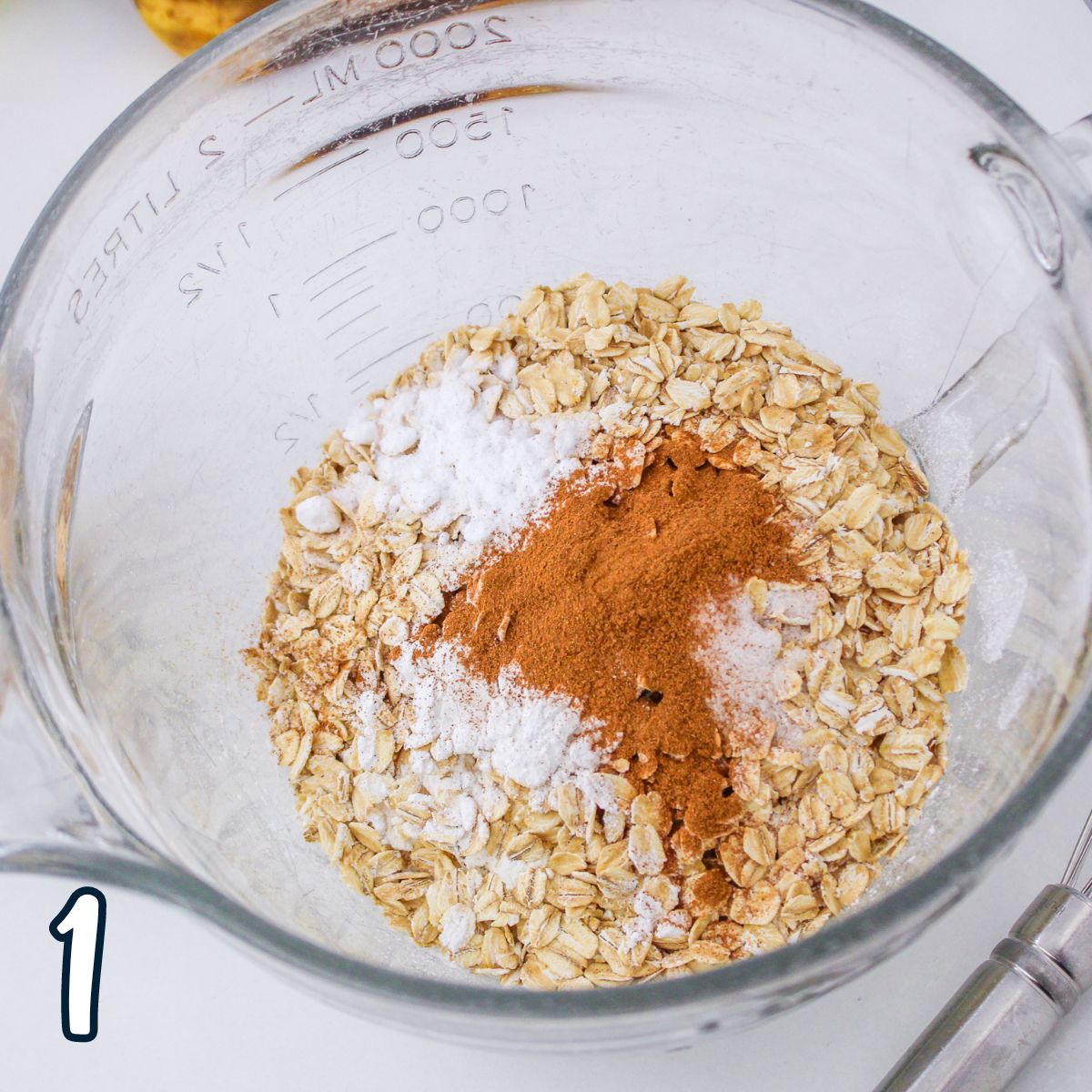 Oats and cinnamon in a glass bowl.