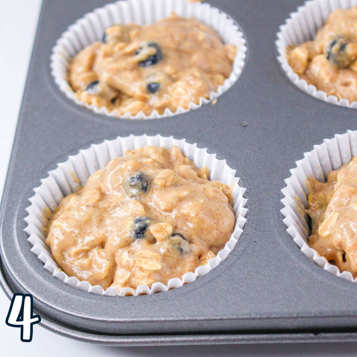 Blueberry oatmeal muffins in a muffin tin.