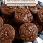 A basket of Chocolate Espresso Muffins with chocolate chips, displayed with a sign describing the ingredients.