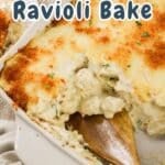 A close-up of a Chicken Ravioli Bake in a rectangular dish. A wooden spoon is serving a portion, revealing the savory layers beneath. The dish is topped with a golden brown crust. The text reads "Chicken & Ravioli Bake".