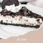 A slice of No Bake Oreo Cheesecake topped with whipped cream and an Oreo cookie on top.