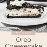 A slice of No Bake Oreo Cheesecake topped with whipped cream and an Oreo cookie sits on a white plate.