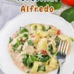 A delectable plate of Chicken and Tortellini Alfredo, garnished with fresh spinach and juicy tomatoes. Text overlay reads, "Chicken & Tortellini Alfredo.