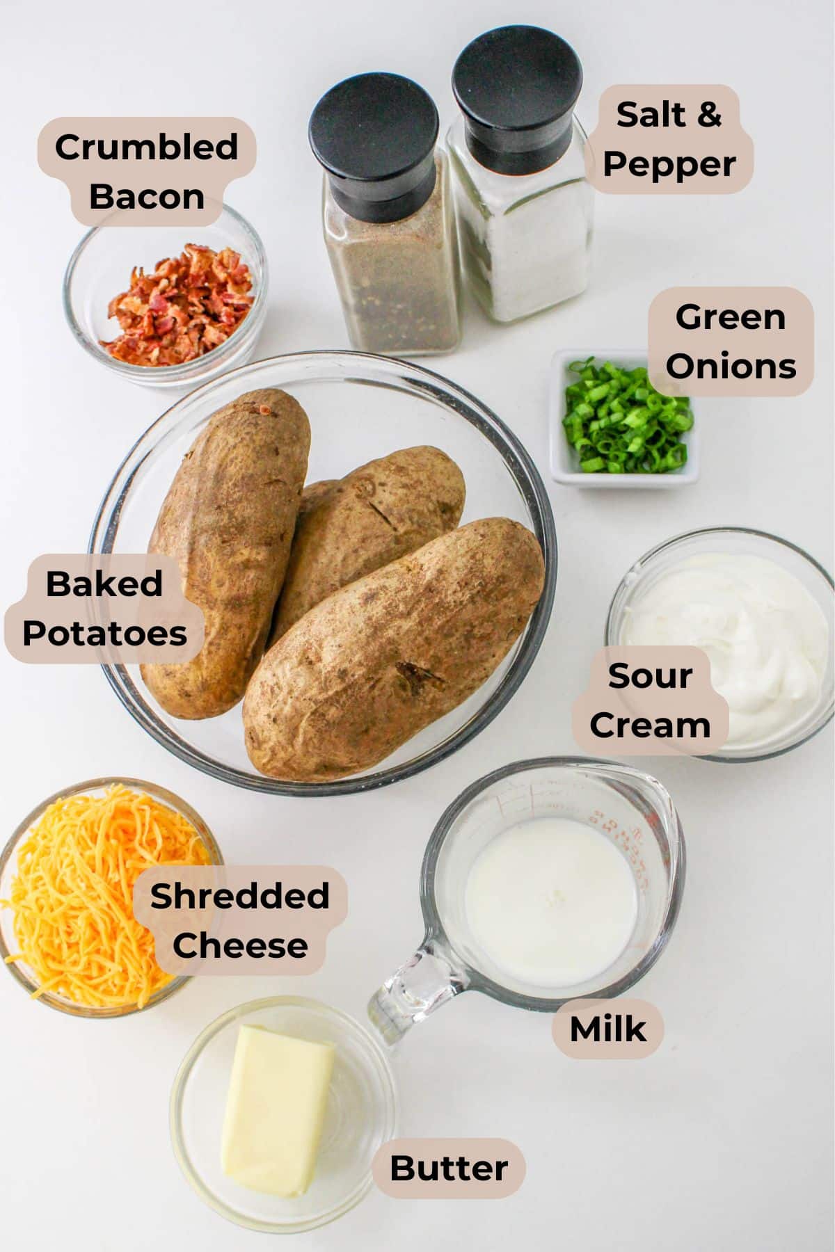 Twice baked mashed potatoes with crumbled bacon, green onions, sour cream, shredded cheese, milk, butter, salt, and pepper.
