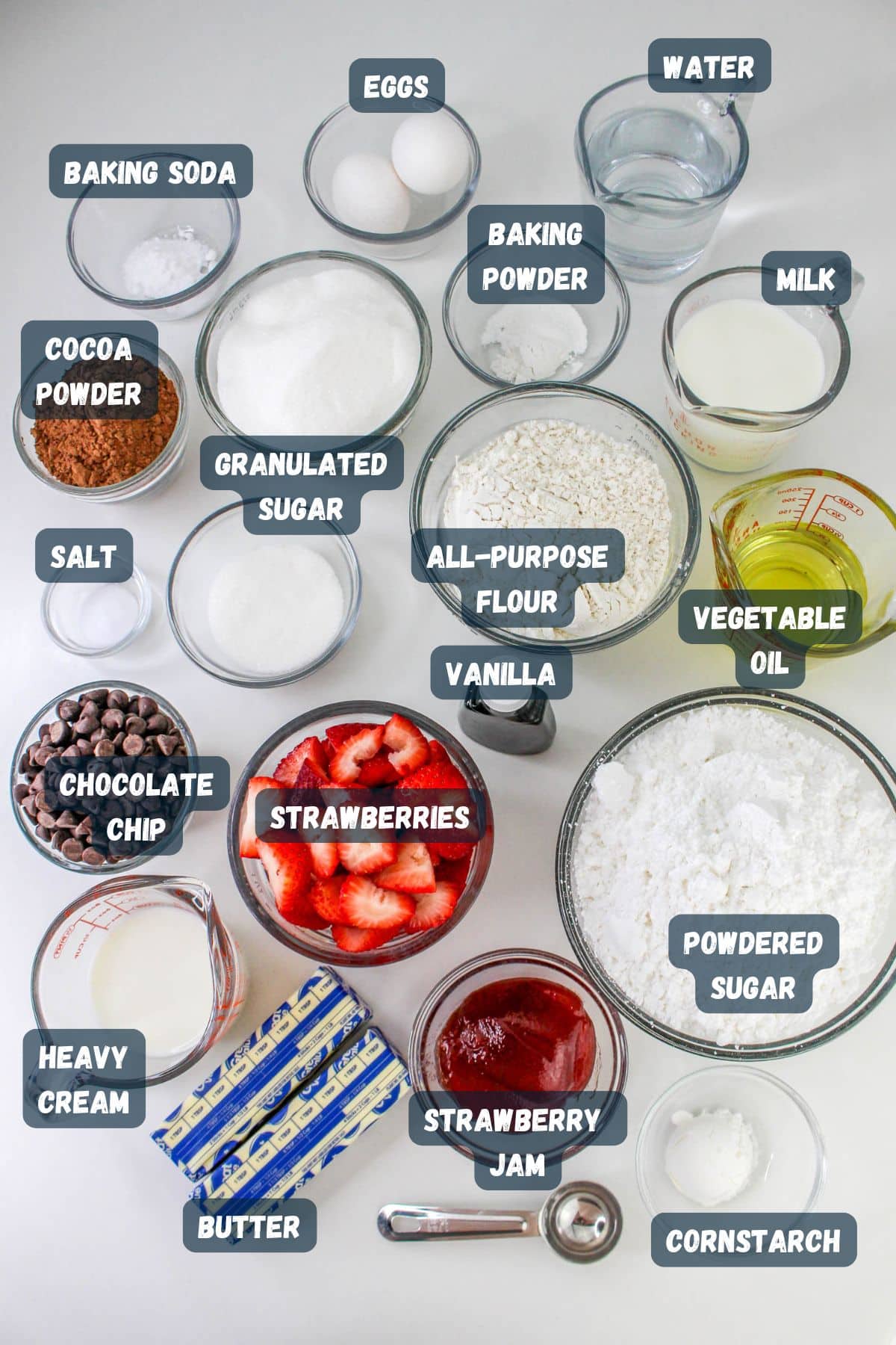 Baking ingredients labeled in bowls and containers, including flour, sugar, eggs, cocoa powder for that rich chocolate taste, and fresh strawberries for a delightful chocolate covered strawberry cake.